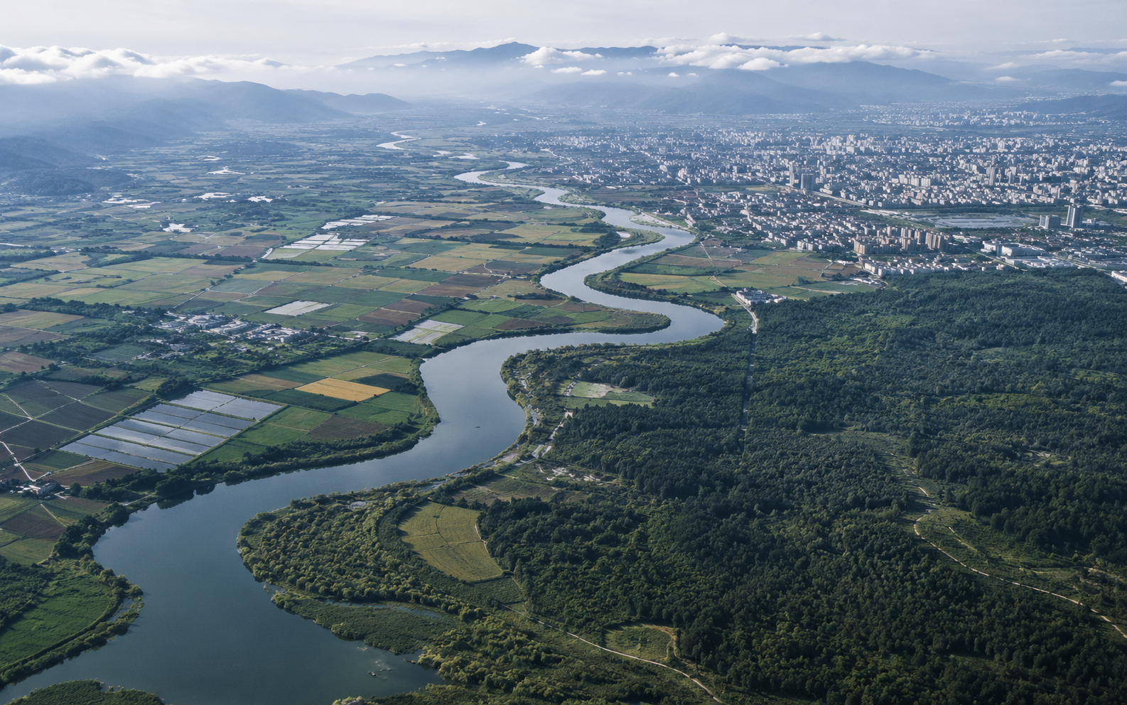 Aerial river, farmland, forest and city landscape observed from above